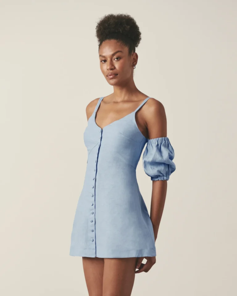 Front view of blue linen button down mini dress with sweetheart neckline and covered buttons.