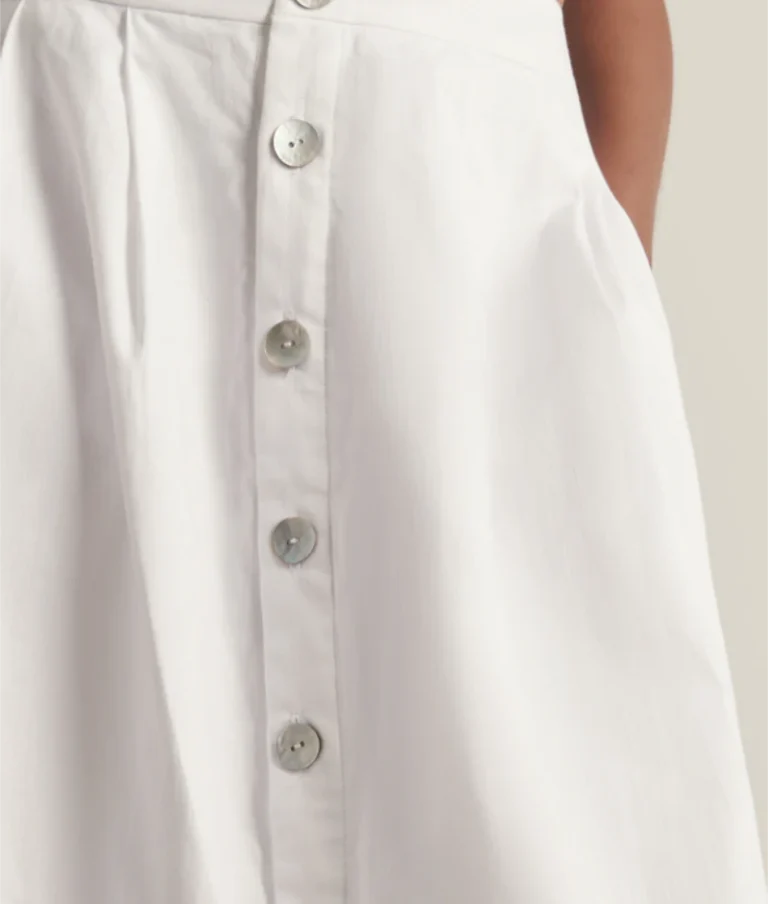 White organic cotton midi skirt with natural shell button fastening.
